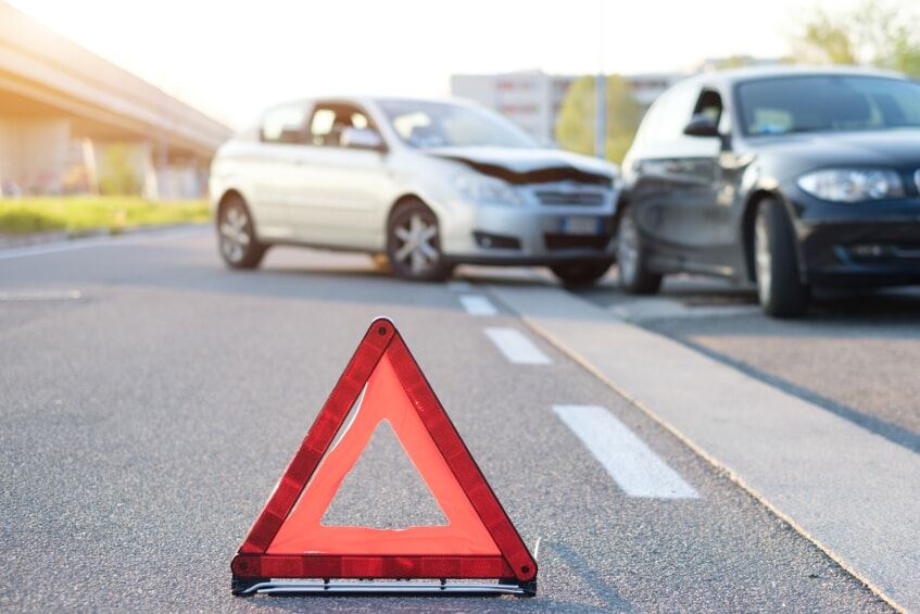 Road hazard sign in front of a car accident