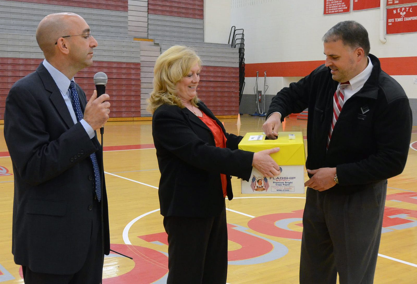 Attorney Christopher Slusser picks a winning name during the Hazleton Area School District's Prom Promise assembly.